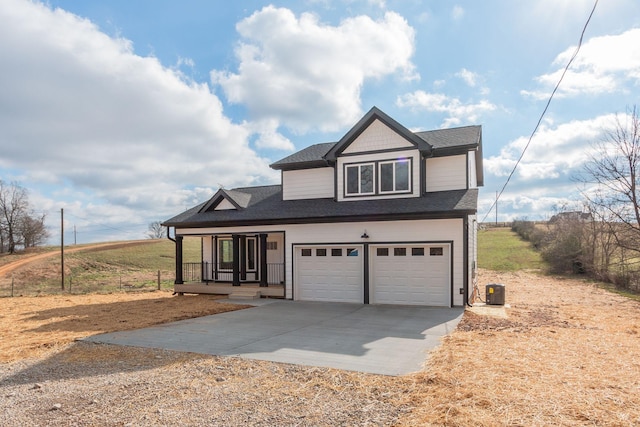 view of front of property with a garage and central air condition unit