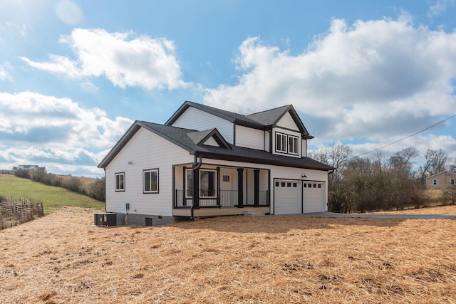 view of front property with a porch and a garage