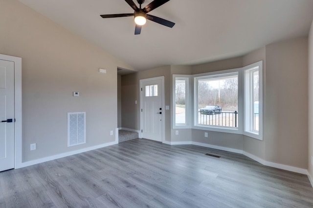 interior space featuring ceiling fan, light hardwood / wood-style flooring, and lofted ceiling