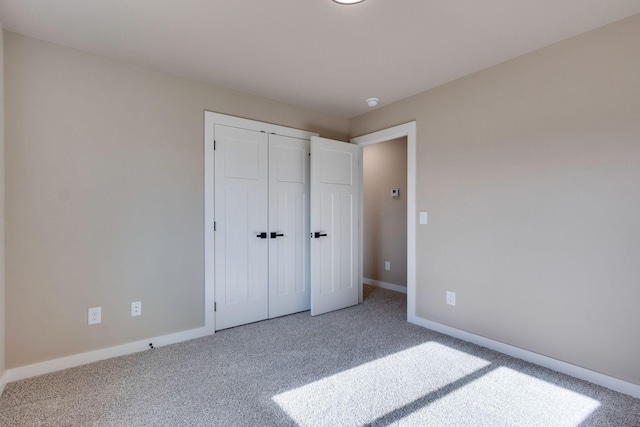 unfurnished bedroom with carpet and a closet