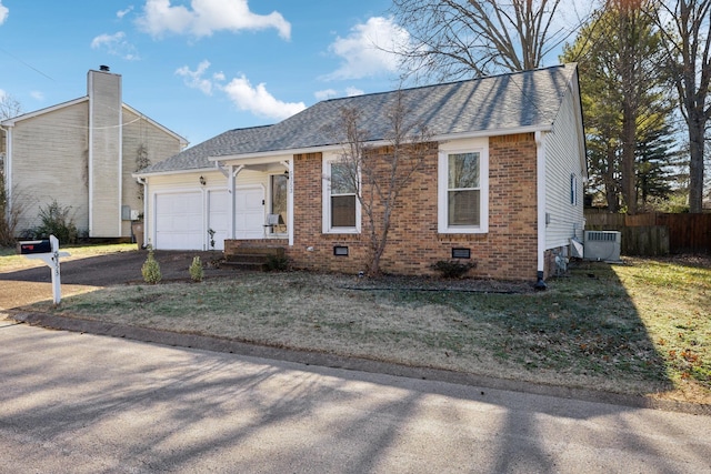 ranch-style house with a front yard, central AC, and a garage