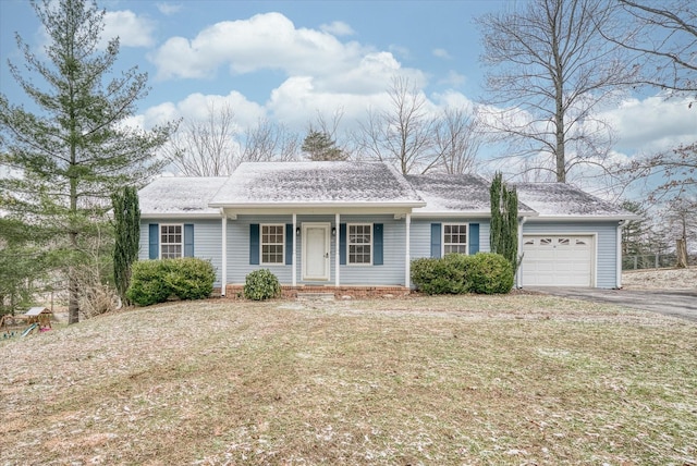 single story home with a front yard and a garage