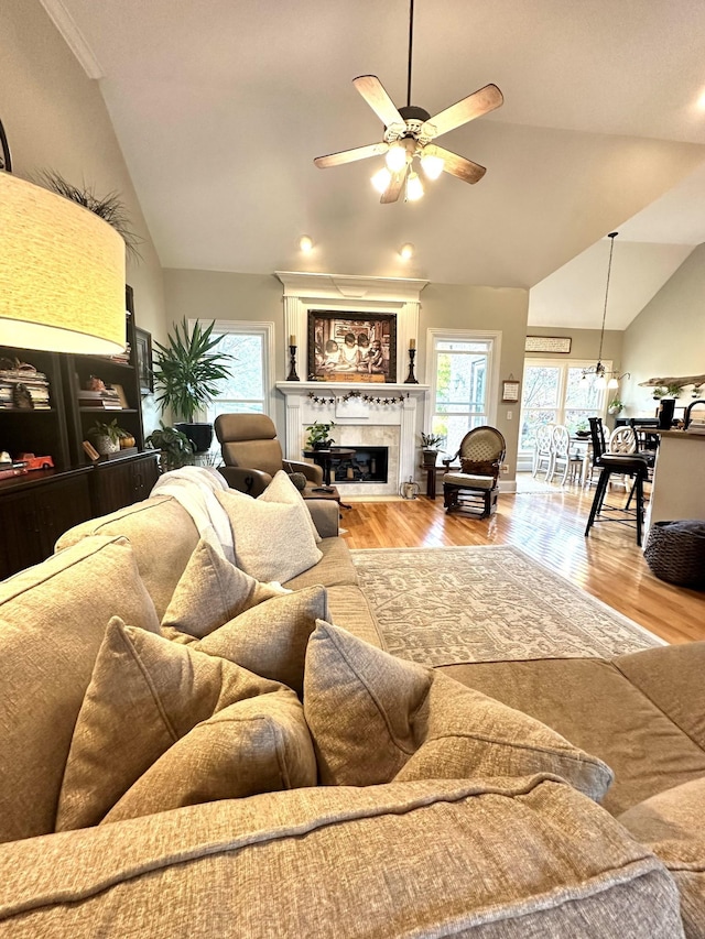 living room featuring light hardwood / wood-style floors, ceiling fan, and lofted ceiling