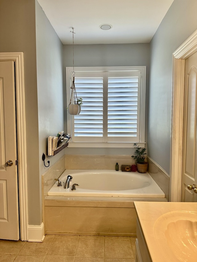 bathroom featuring tile patterned flooring, vanity, and a bathtub