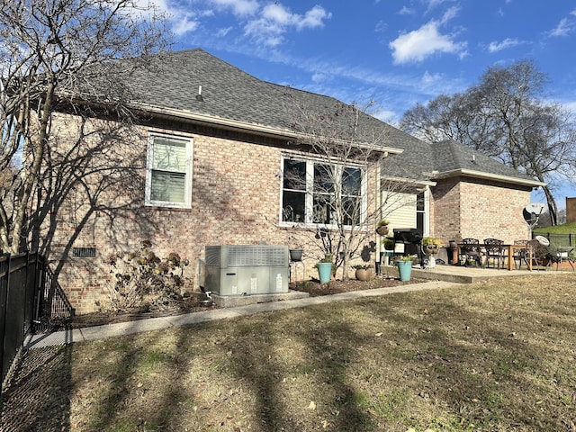 back of property with a yard and cooling unit