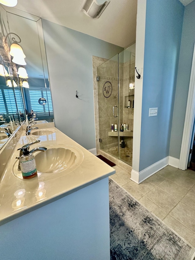 bathroom featuring tile patterned floors, vanity, and an enclosed shower