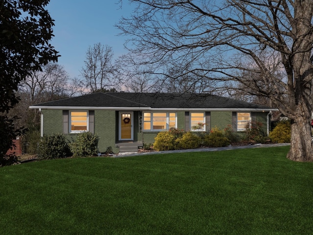 ranch-style home with a lawn