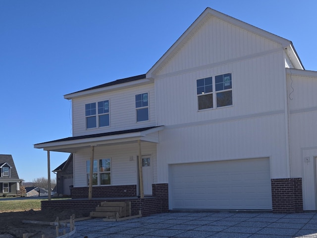 view of front of property with a porch and a garage