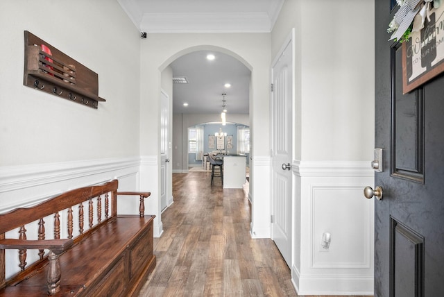 hall with dark hardwood / wood-style floors and crown molding