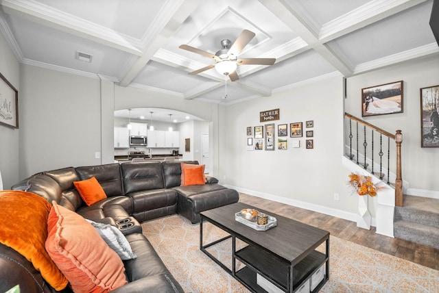 living room featuring coffered ceiling, ceiling fan, crown molding, beam ceiling, and wood-type flooring