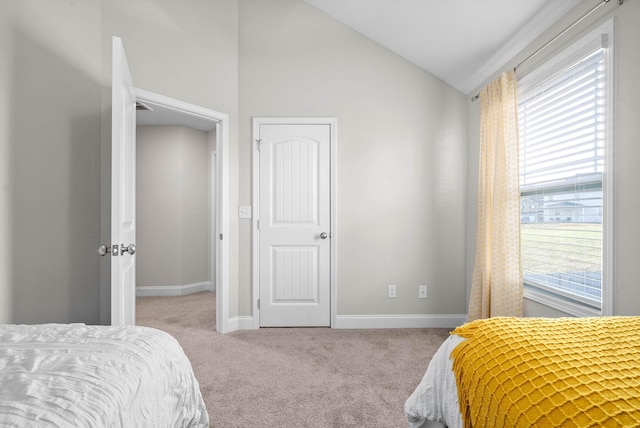 carpeted bedroom featuring vaulted ceiling