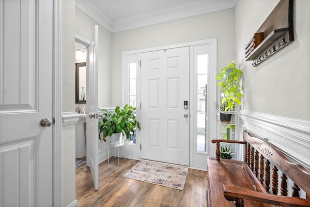 entryway with hardwood / wood-style flooring and ornamental molding