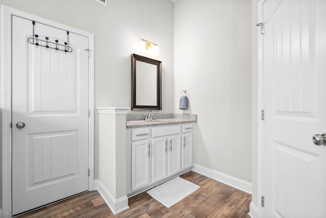 bathroom featuring vanity and hardwood / wood-style flooring