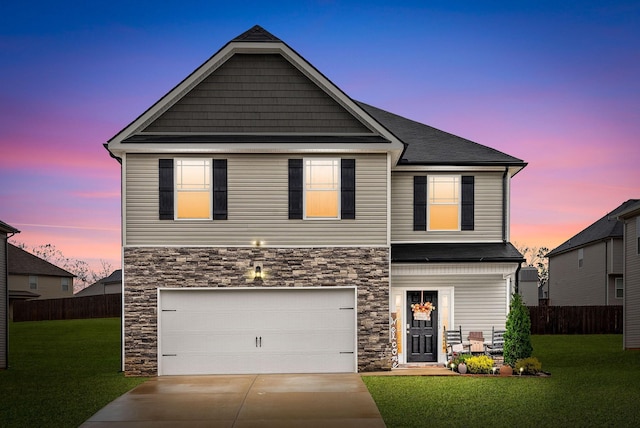 view of front of home featuring a yard and a garage