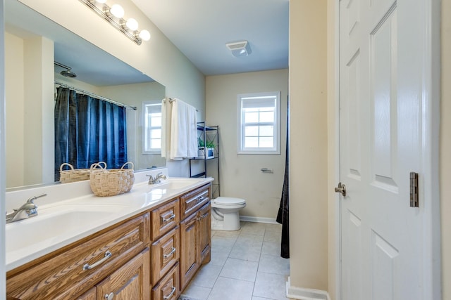 bathroom with tile patterned floors, vanity, and toilet