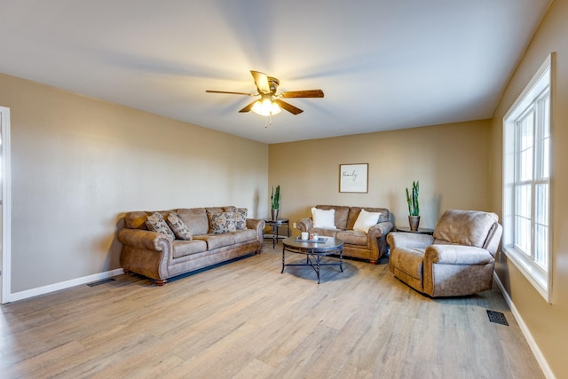 living room with ceiling fan and light hardwood / wood-style floors