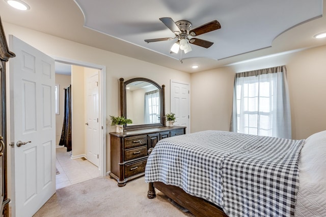 carpeted bedroom featuring ceiling fan and multiple windows