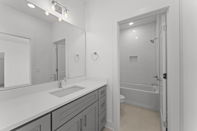 full bathroom with toilet, tiled shower / bath combo, tile patterned floors, and vanity