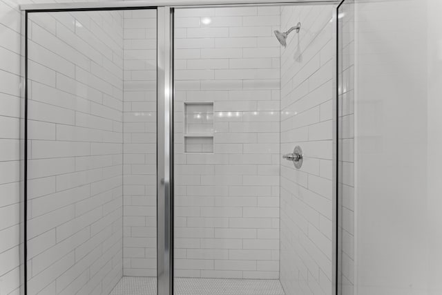 room details featuring a shower with door