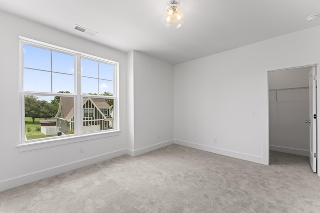 unfurnished room with light colored carpet