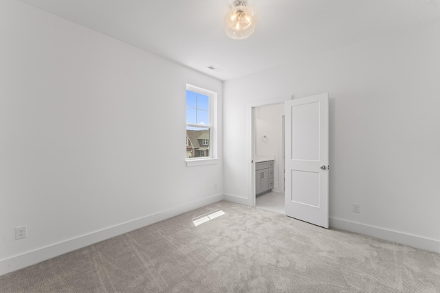 unfurnished bedroom featuring light carpet