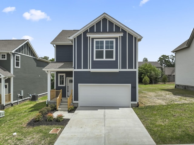 view of front of house featuring a front yard, central AC unit, and a garage