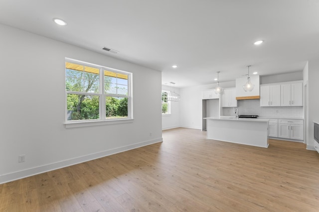 unfurnished living room featuring light hardwood / wood-style flooring