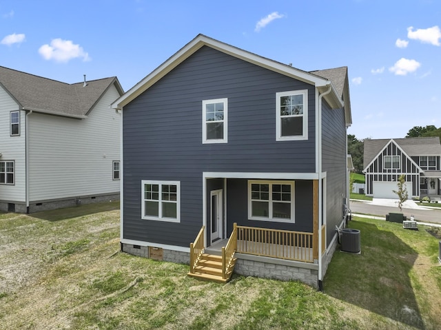 back of house with central AC, a yard, and covered porch