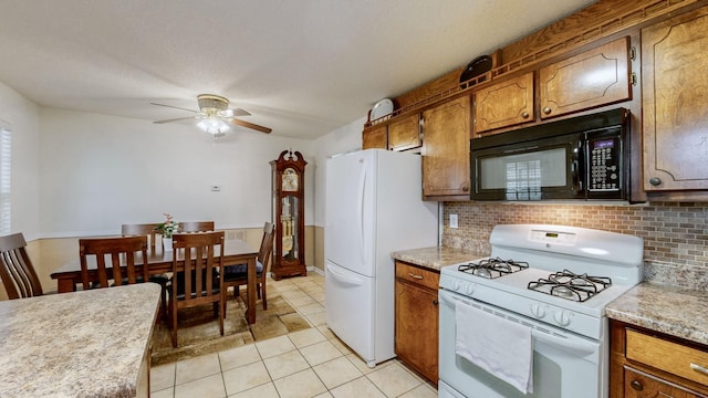 kitchen with white appliances, decorative backsplash, ceiling fan, light tile patterned floors, and a textured ceiling