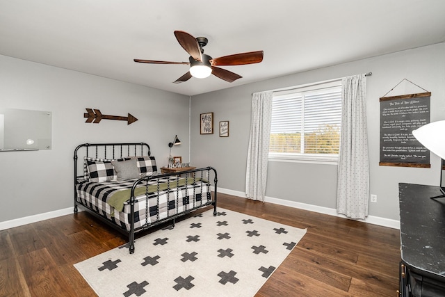 bedroom with ceiling fan and dark hardwood / wood-style flooring