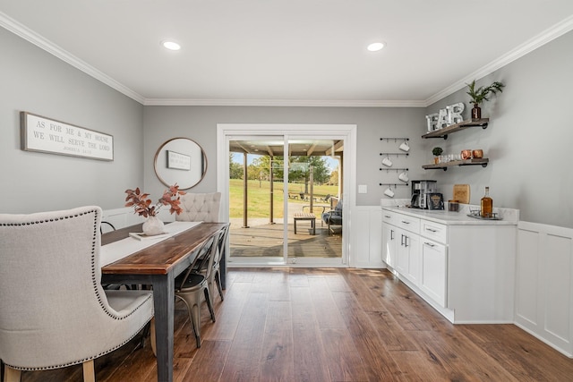 dining room featuring hardwood / wood-style flooring and ornamental molding