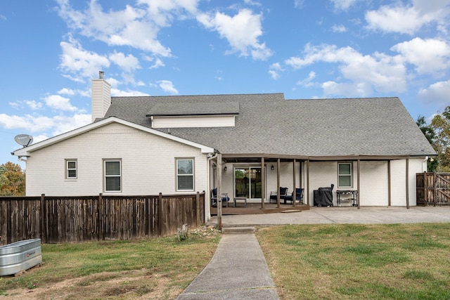 rear view of property with a patio area and a yard