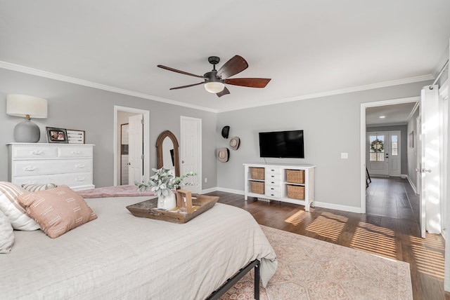 bedroom featuring ceiling fan, dark hardwood / wood-style flooring, crown molding, and ensuite bath