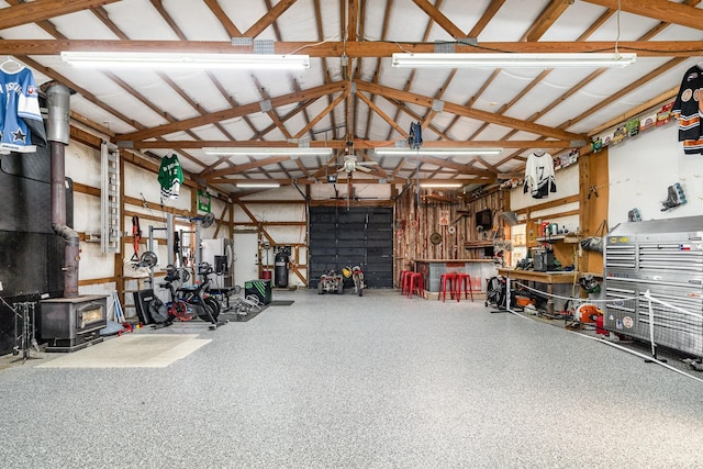 garage featuring a workshop area and a wood stove