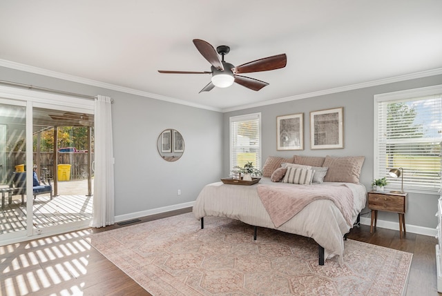 bedroom with multiple windows, access to exterior, and ceiling fan