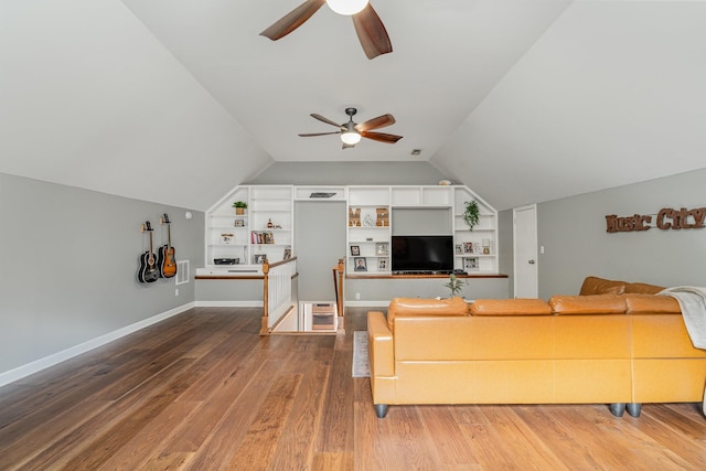 living room featuring ceiling fan, built in features, hardwood / wood-style floors, and vaulted ceiling