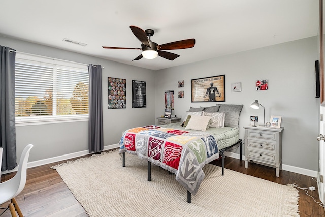 bedroom with ceiling fan and dark wood-type flooring