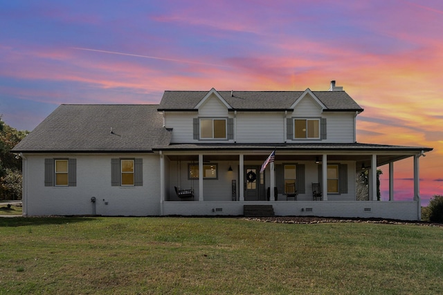 view of front of property with a lawn and a porch