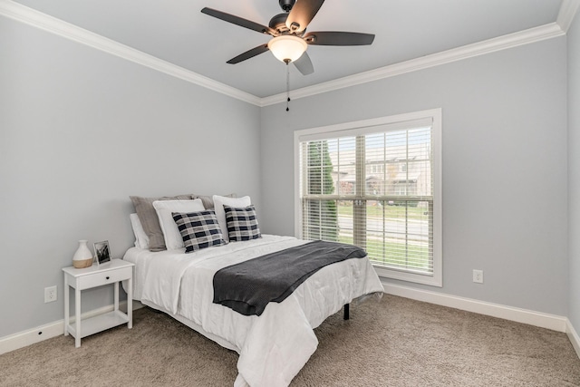 carpeted bedroom with ceiling fan and ornamental molding