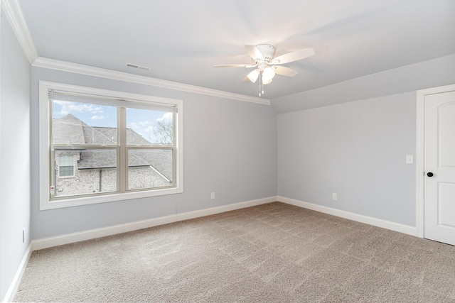 carpeted spare room featuring ceiling fan, crown molding, and vaulted ceiling