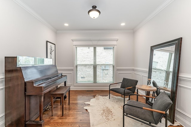 living area featuring crown molding and dark wood-type flooring