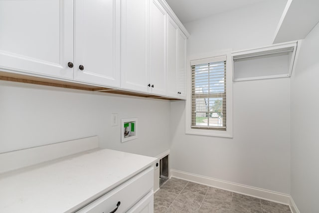 laundry room with washer hookup and cabinets