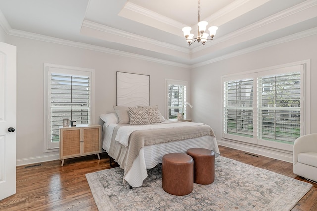 bedroom with a chandelier, a raised ceiling, crown molding, and multiple windows