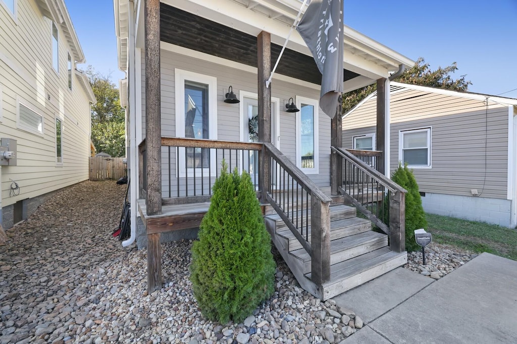 view of exterior entry featuring covered porch