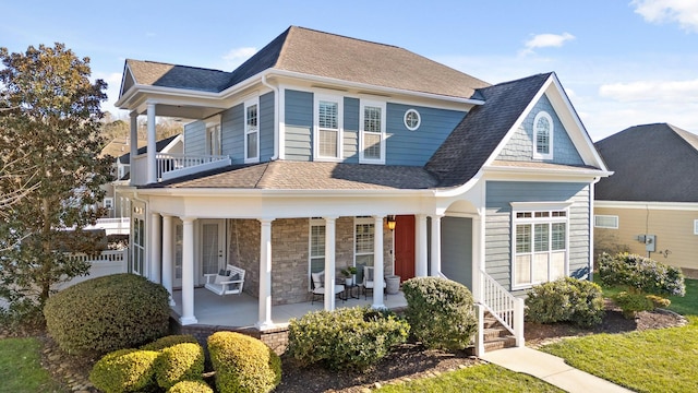 view of front of property with covered porch and a balcony