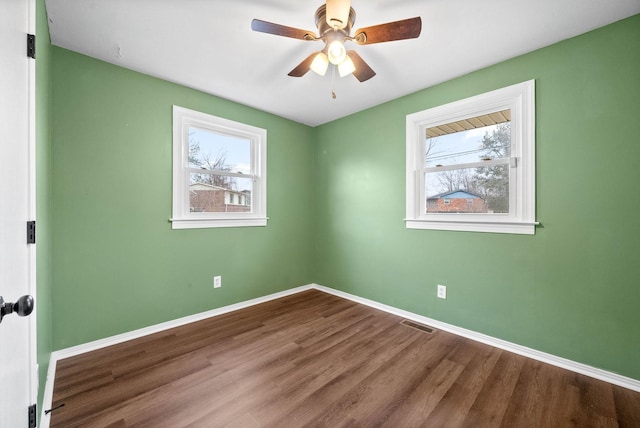 spare room with wood-type flooring and ceiling fan