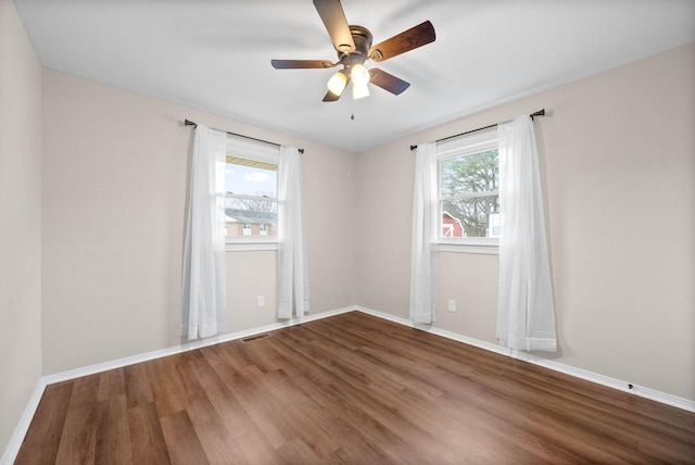 spare room featuring hardwood / wood-style flooring and ceiling fan