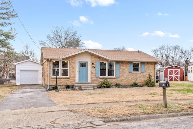 view of front of house featuring a garage and a storage unit