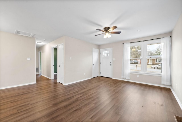 spare room featuring ceiling fan and dark hardwood / wood-style flooring