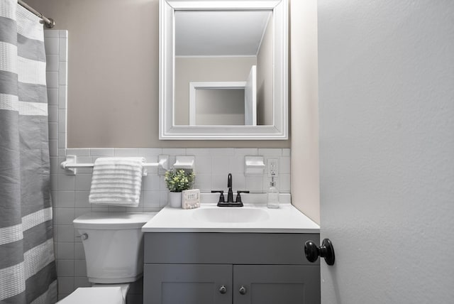 bathroom featuring vanity, tile walls, and toilet